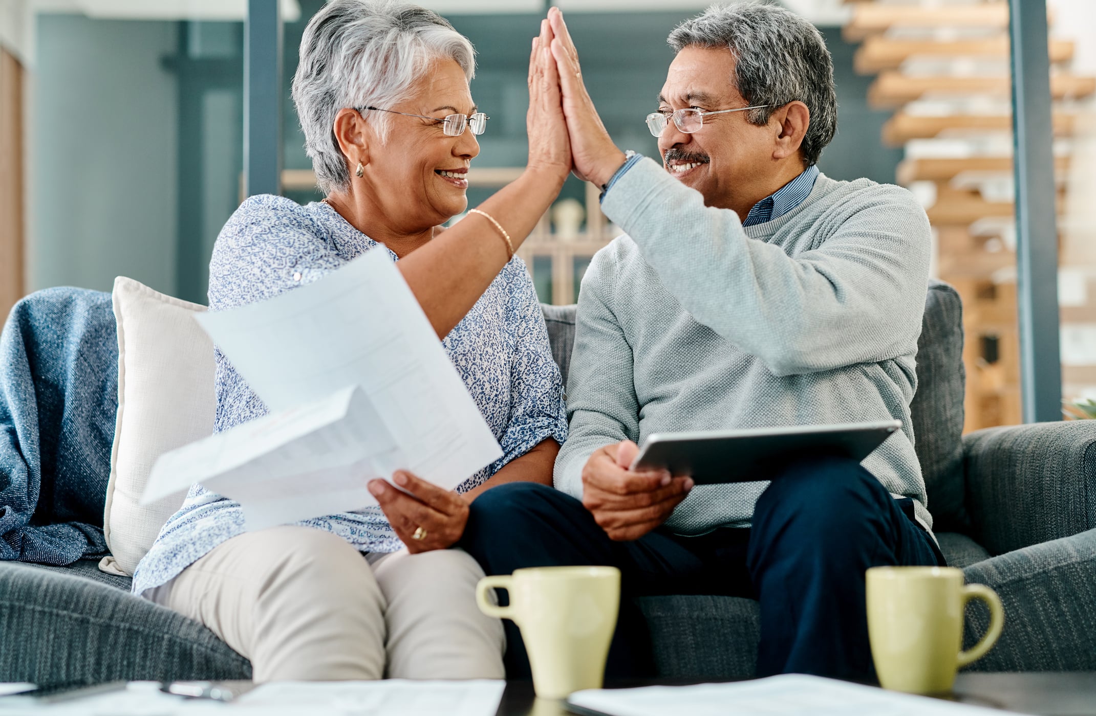 Michigan Gold IRA Investing Company getty couple high five happy
